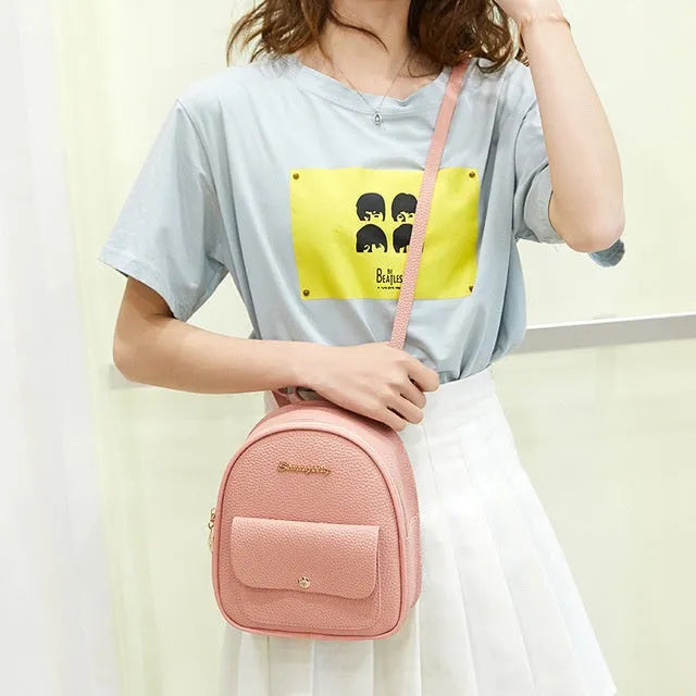 Women's small black PU backpack purse with letter design and zipper closure