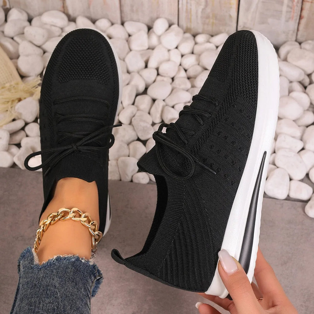 Women's red fly-knit casual sneakers with round toe and lace-up front.