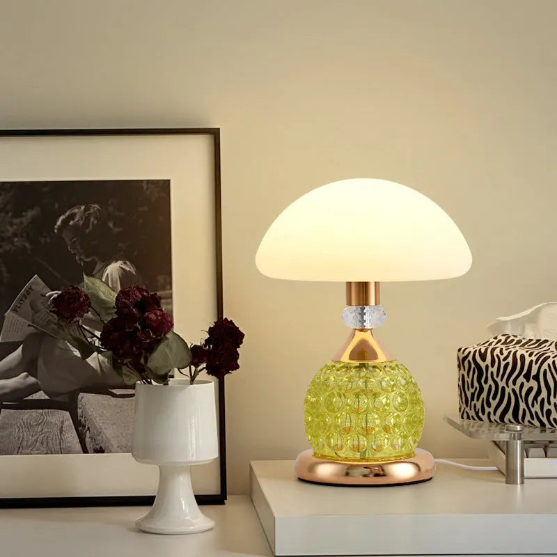 Light luxury mushroom table lamp with carved base in transparent colour on a wooden bedside table