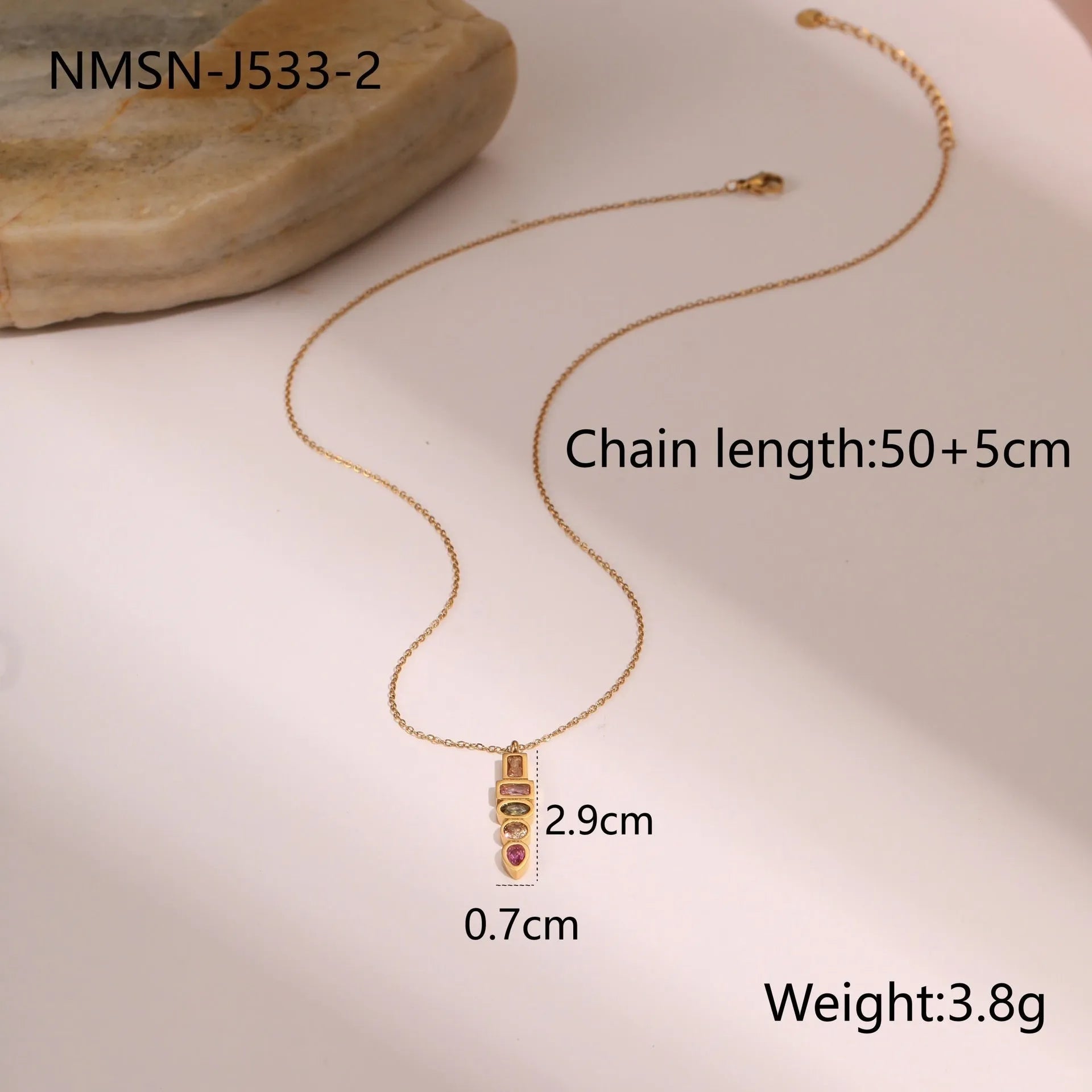 Geometric gold-plated jewellery set with necklace, earrings, and ring on display