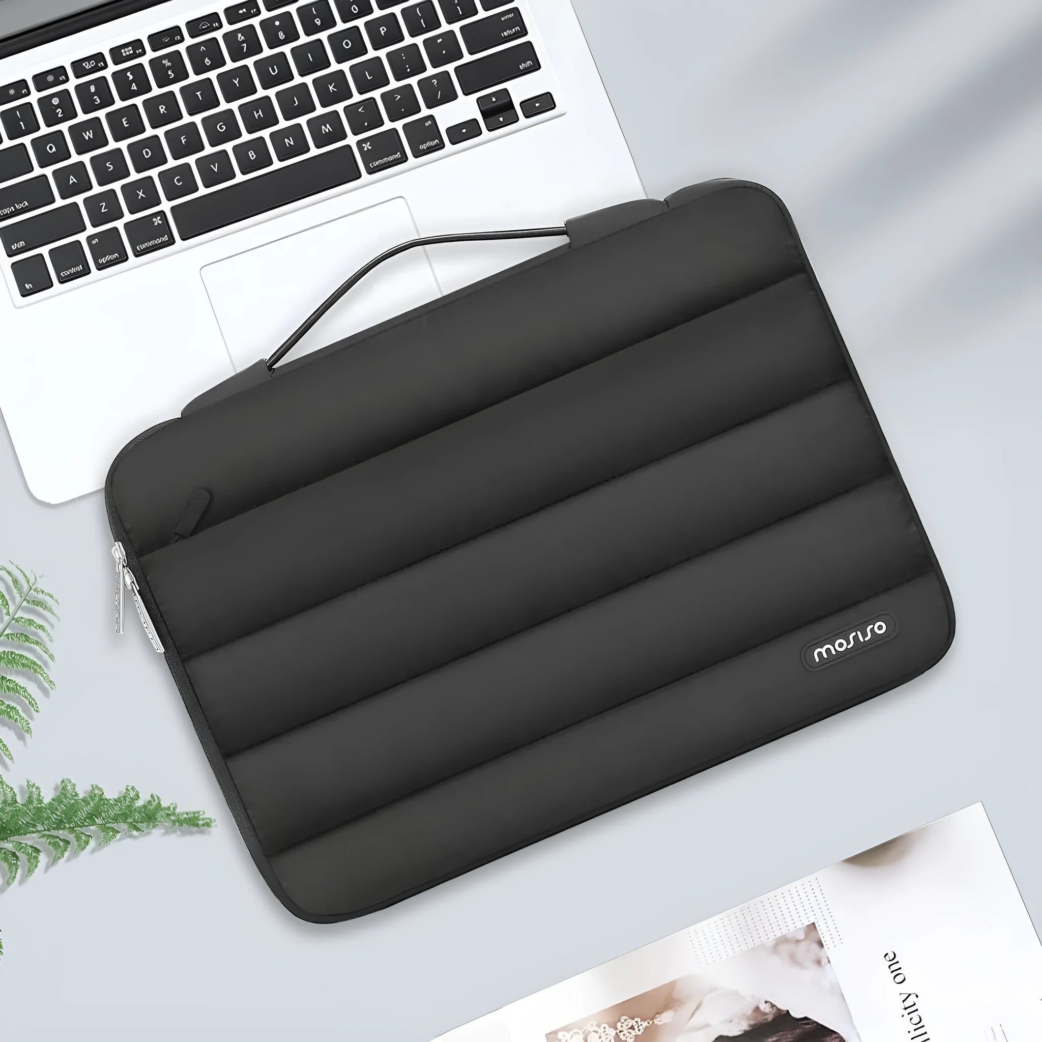 Cotton velvet laptop storage bag in black with plaid pattern, shown next to a laptop.