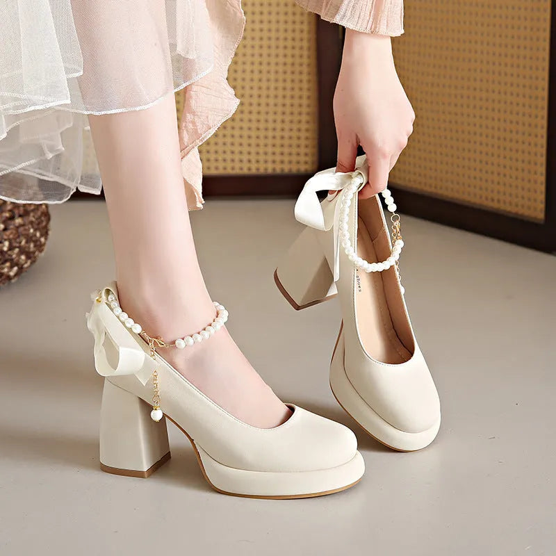 Women's beige Mary Jane shoes with a chunky heel, round toe, and a buckle fastening on the ankle strap.