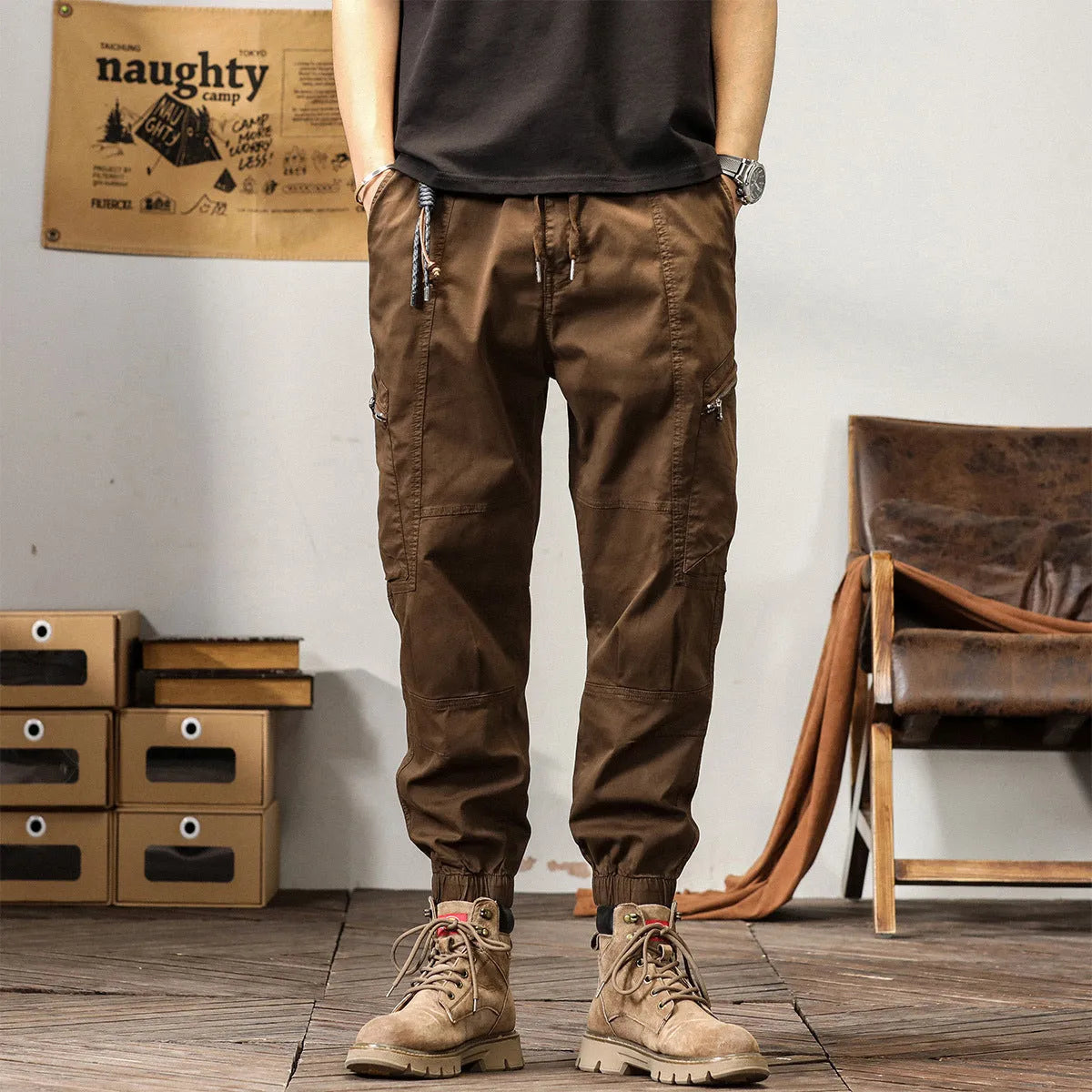 Men's loose fit cotton trousers with tapered ankle banded legs in khaki colour.