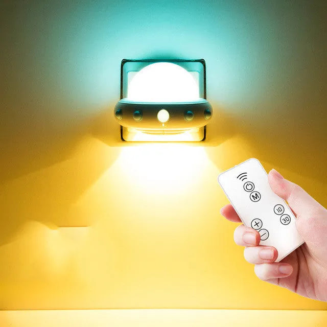 Remote control UFO shaped bedside night light in blue, pink, or white with cartoon design