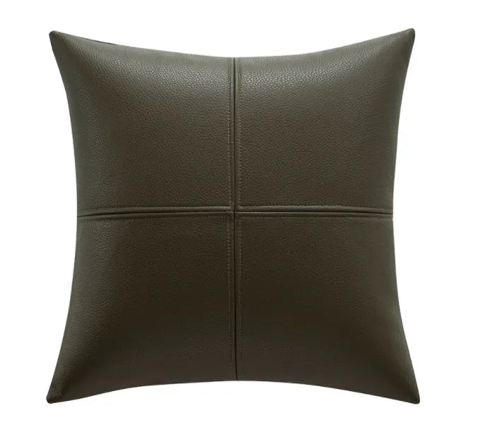 Soft cowhide leather pillow cover in a solid colour on a sofa.