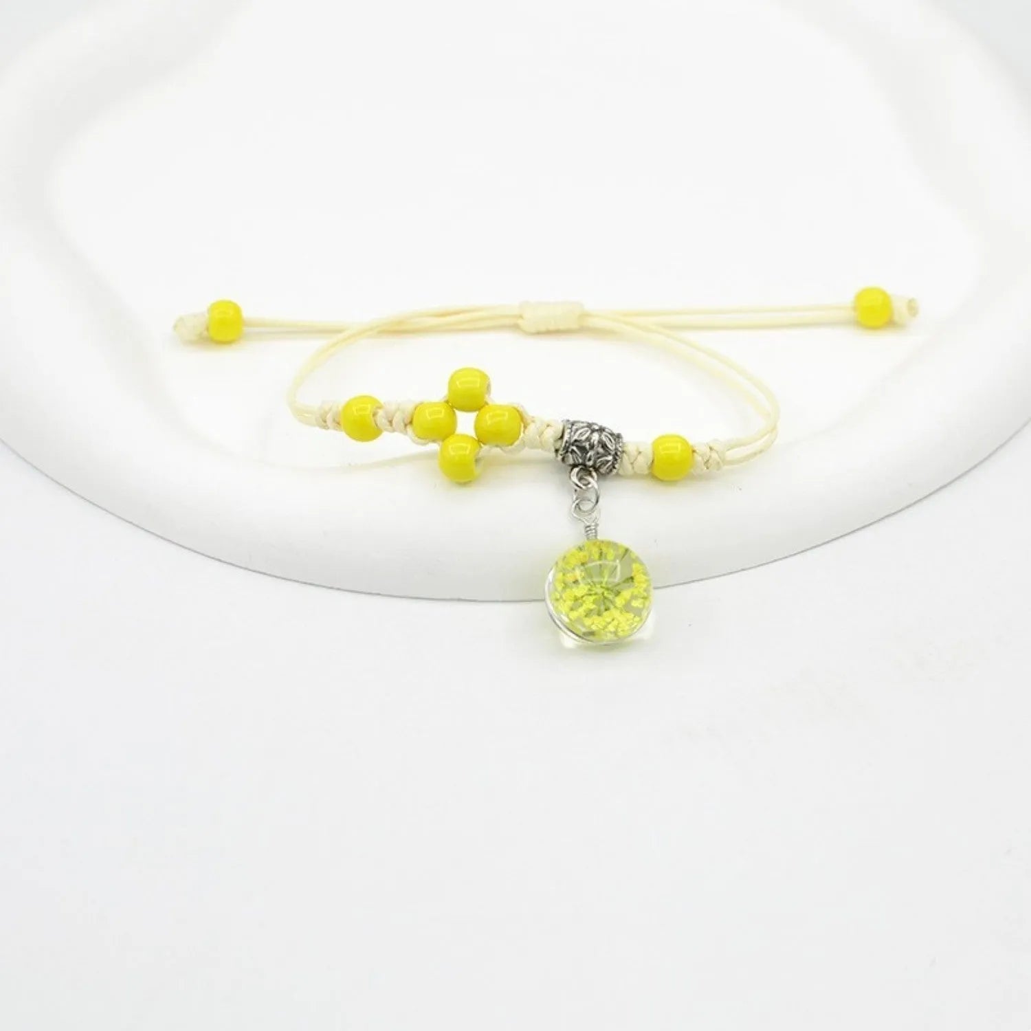 Hand-woven glass bracelet with 1.4cm beads containing real dried flowers in various colours