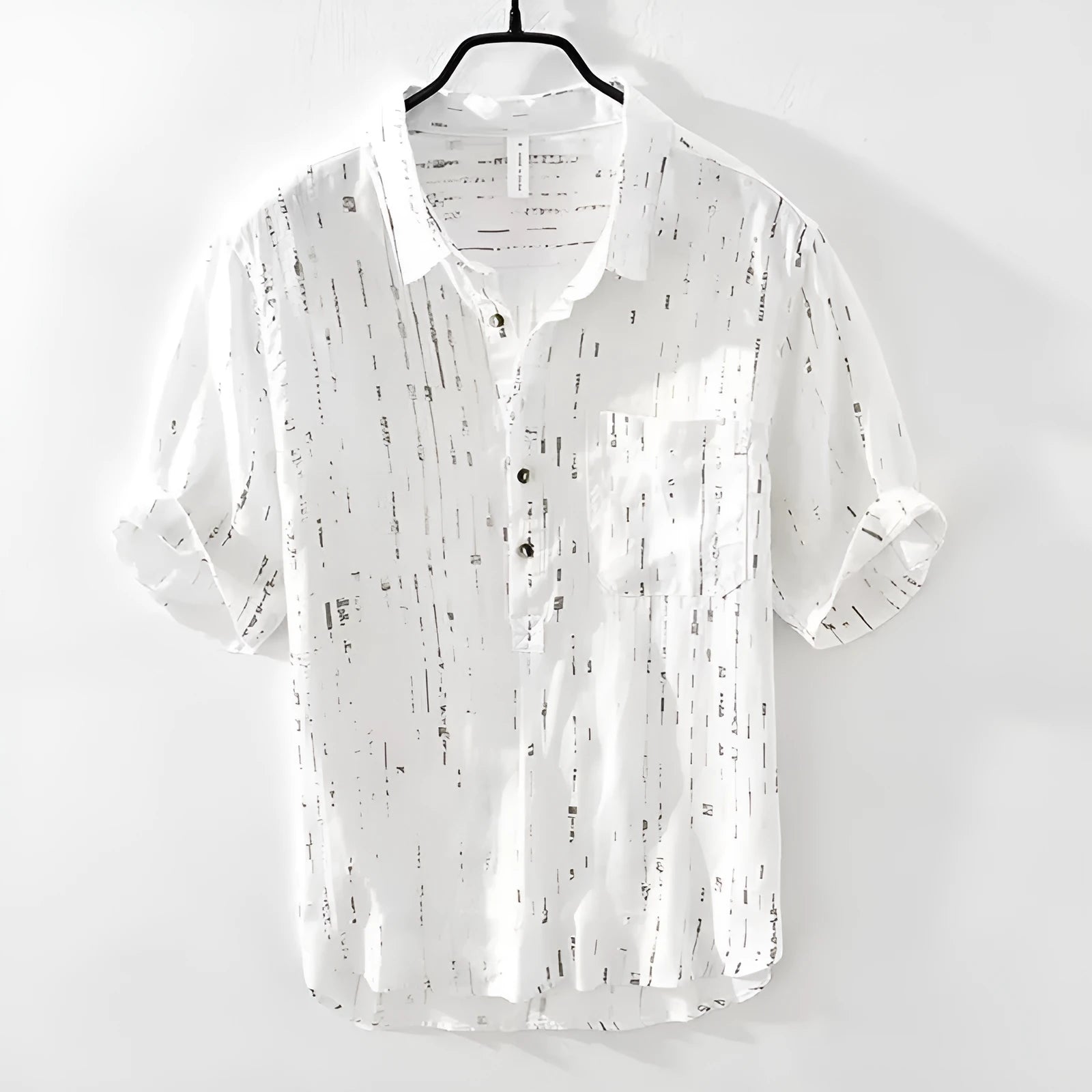 A man's loose-fit short-sleeved polo shirt in black, showing the lapel collar and casual cardigan style.