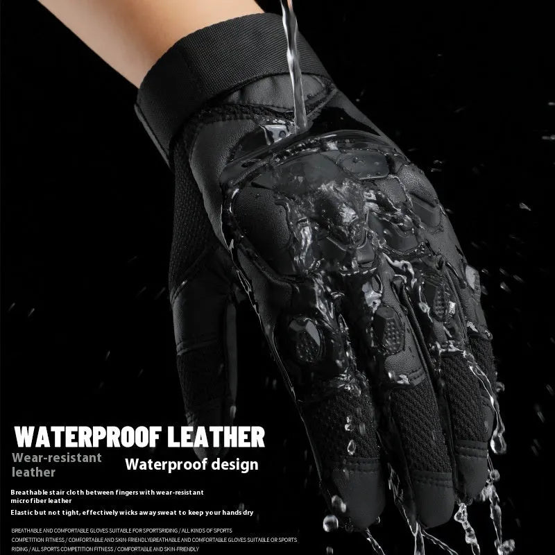 Men's black full finger tactical gloves with touch screen fingertips on a hand holding a phone.