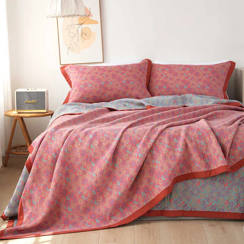 Cotton gauze bed blanket set with floral patterns showing blanket and two pillowcases