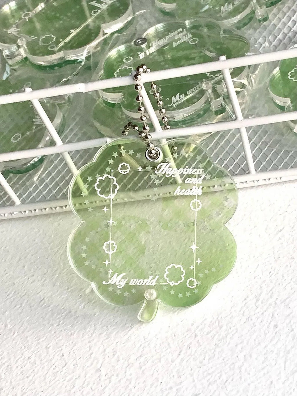 Acrylic four-leaf clover phone pendant keychain on a ring in blue, green, or mint.