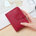 Ladies' short PU leather wallet with lychee pattern, shown in bifold open view.