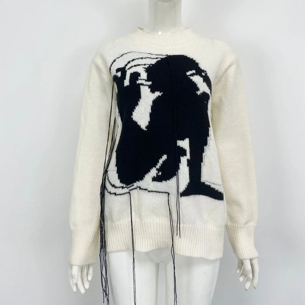 Grey women's loose alpaca wool sweater with tassel detail and abstract pattern, round neck.