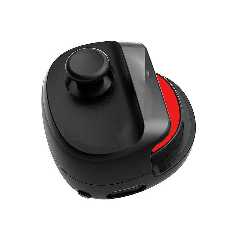 Black and white USB gaming stick controller on a desk, showing compact square design.