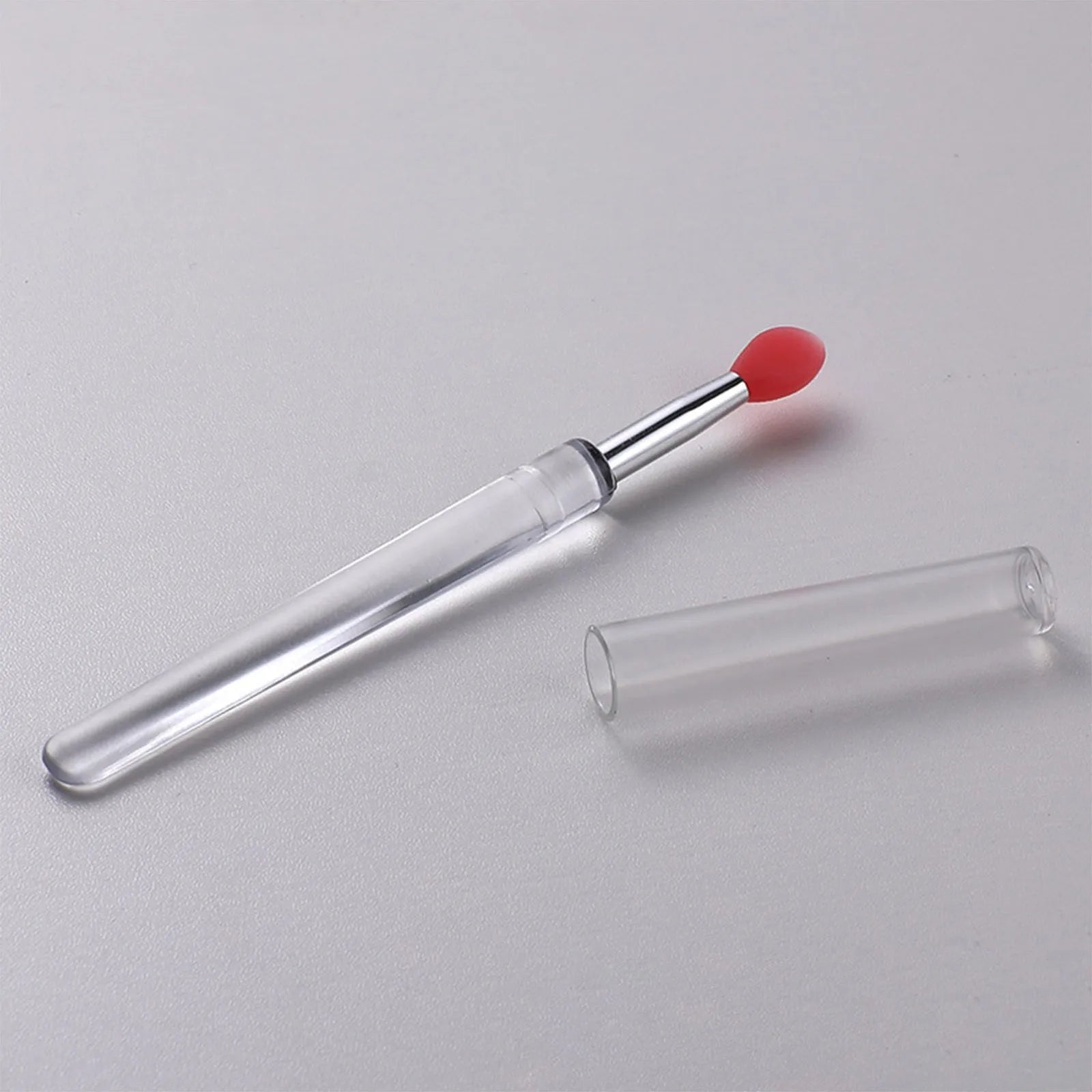 Set of reusable silicone lip brushes with protective caps in various colours.