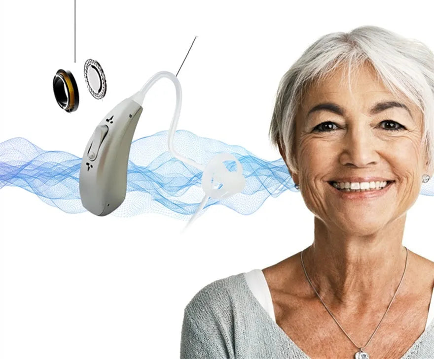A small, wireless invisible hearing aid and its portable USB charging case.