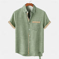 Linen short-sleeved casual shirt with a printed ocean fish pattern, shown in a loose fit.