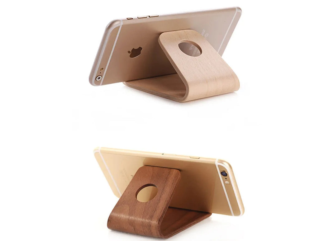Solid wood iPhone stand in walnut finish on a desk