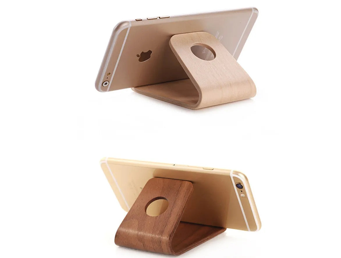 Solid wood iPhone stand in walnut finish on a desk