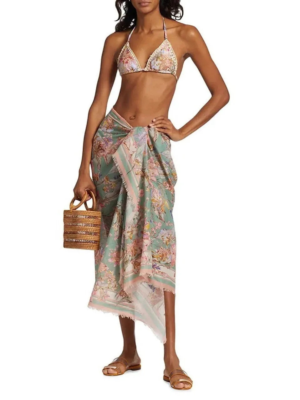 Creamy-white floral women's bikini set with matching skirt on beach