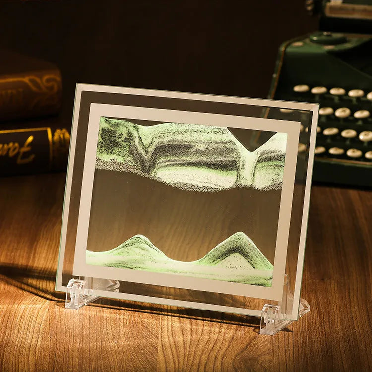 Geometric glass ornament with internal landscape quicksand painting in black, white and green colours.