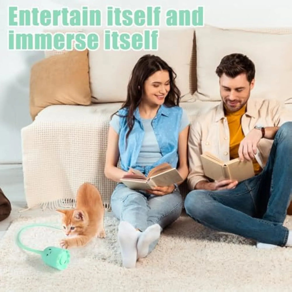 Green automatic cat toy with swinging silicone tails on a white surface