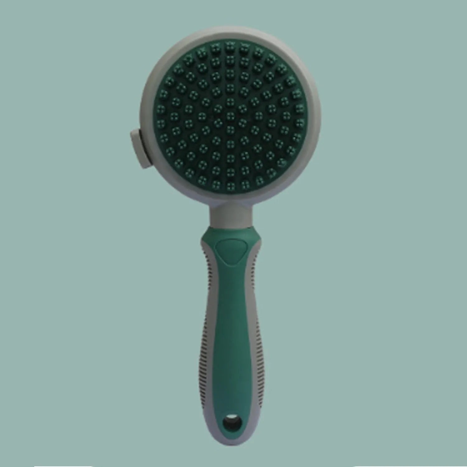 Green and pink reversible cat brush showing slicker brush side and flea comb side with release button