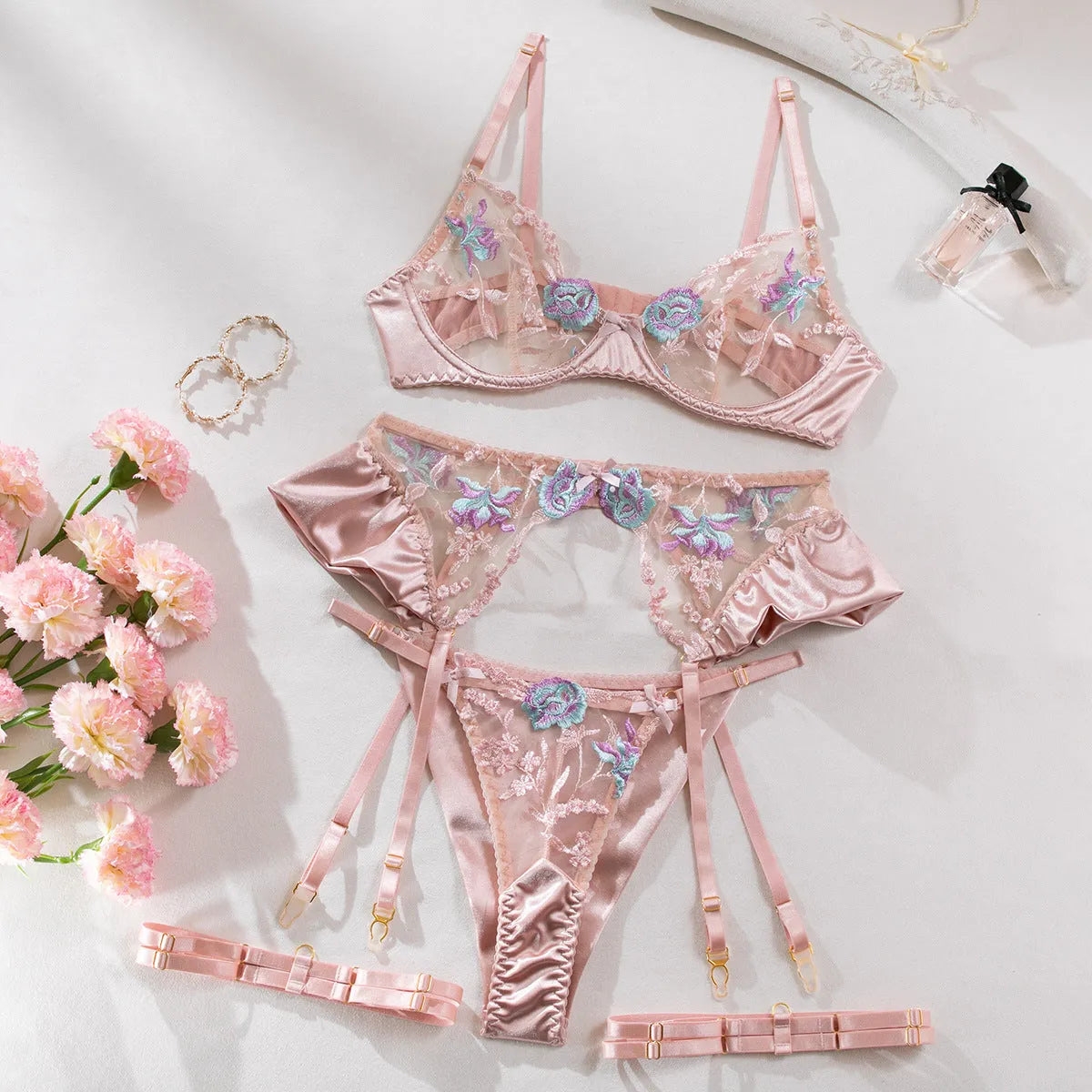 Light purple satin four-piece lingerie set with embroidery detail.