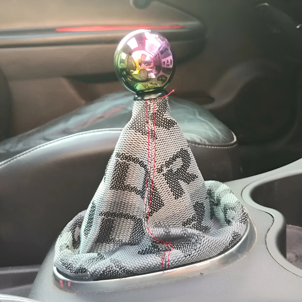 Canvas dust cover draped over a racing bucket seat in a vehicle interior.