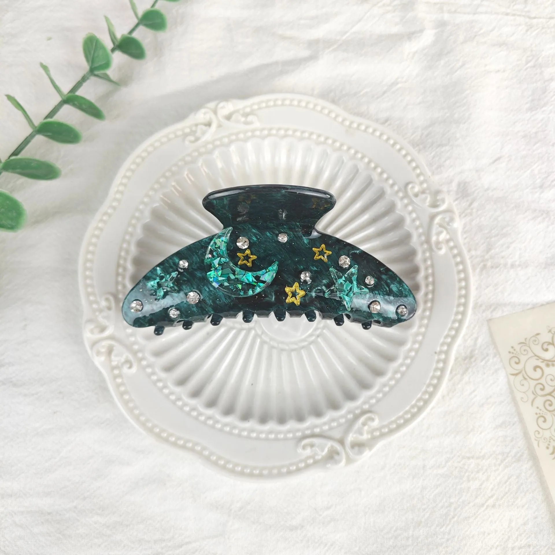 Oversized women's barrette with star moon starry sky pattern in sky blue colour.