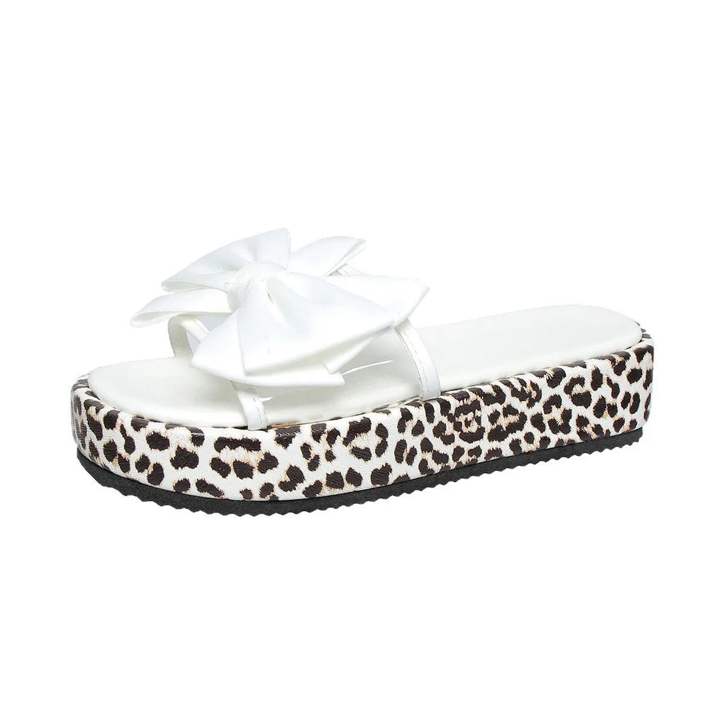 Women's black and white leopard print beach slippers with a thick platform sole.