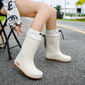 Women's solid colour PVC rain boots with non-slip soles in apricot, black, brown, and pink waterproof mouth options