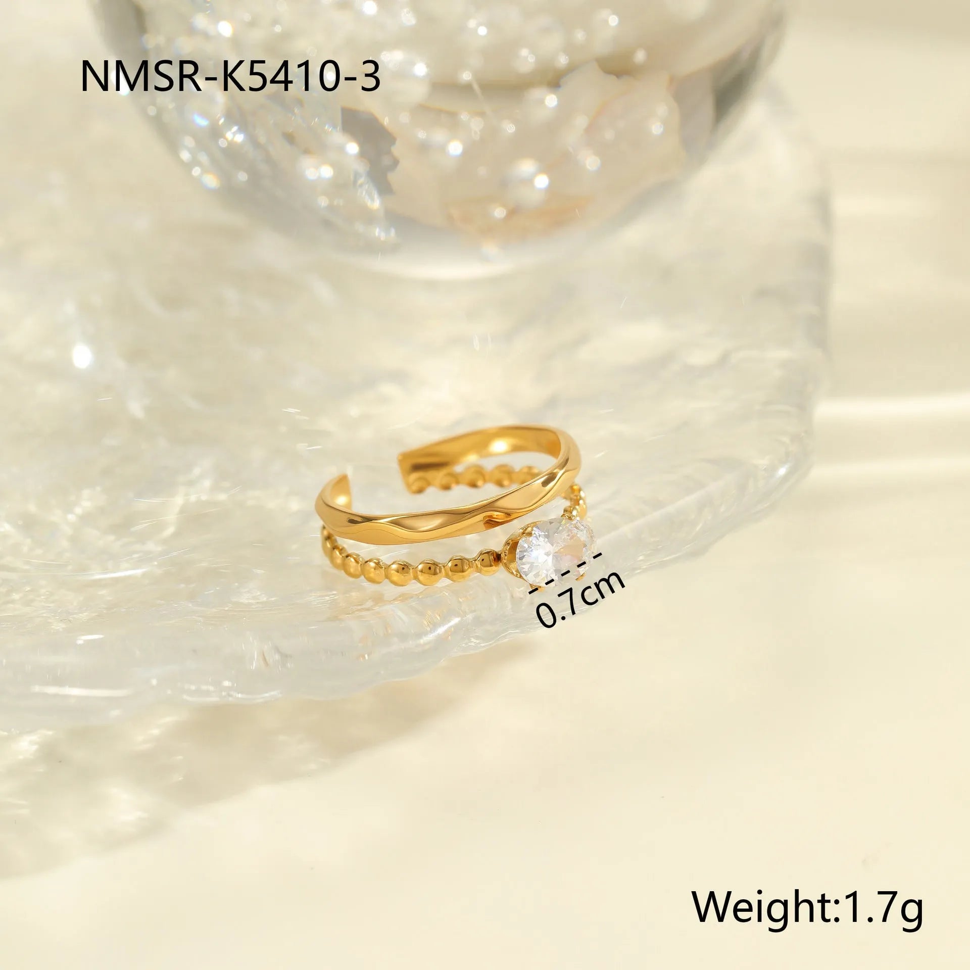 Gold-coloured adjustable stainless steel ring with zircon geometric shapes on white background.