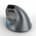 Grey vertical handheld grip Bluetooth wireless mouse for laptops on a desk.