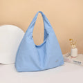Women's soft nylon underarm bag in a heart shape, shown in black, blue, khaki, and yellow colour options.
