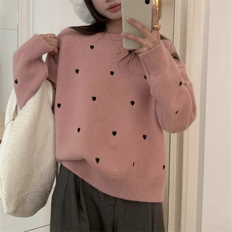Women's loose-fit acrylic pullover sweater with embroidered heart detail on the front.