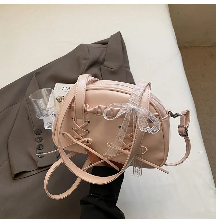Ladies shoulder handbag with bandage bow design in PU leather showing phone pocket compartment