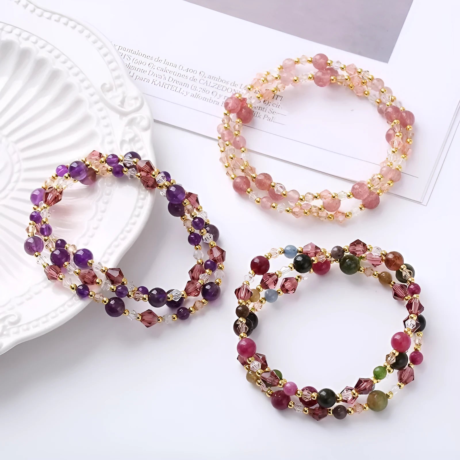 Women's adjustable three-ring bracelet with colourful tourmaline, strawberry quartz, and amethyst crystals on a cord.