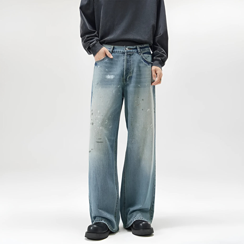 Men's loose fit splash-ink washed denim jeans in Ice Blue on a model, front view