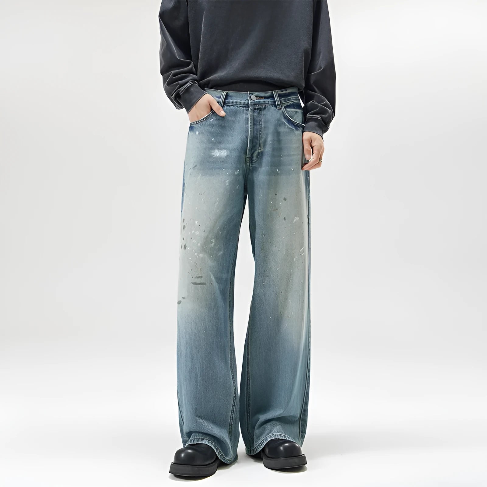 Men's loose fit splash-ink washed denim jeans in Ice Blue on a model, front view