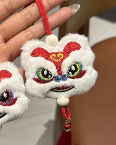 Blue and yellow handmade plush lion keychain with star stones and tassels in Chinese cartoon style