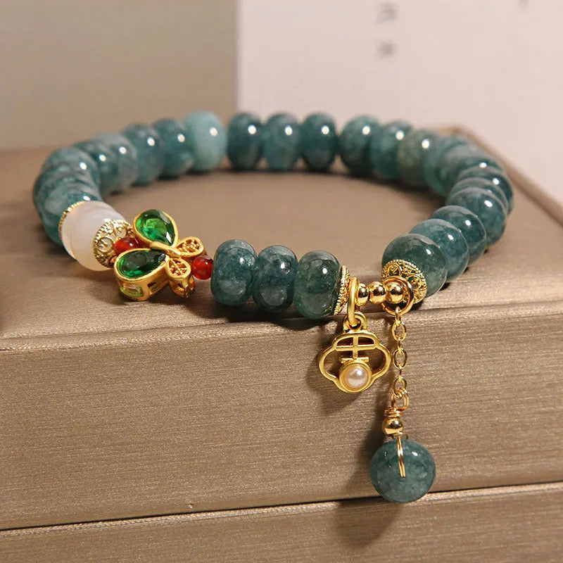 Blue water jade abacus bead bracelet with white agate and butterfly charm design