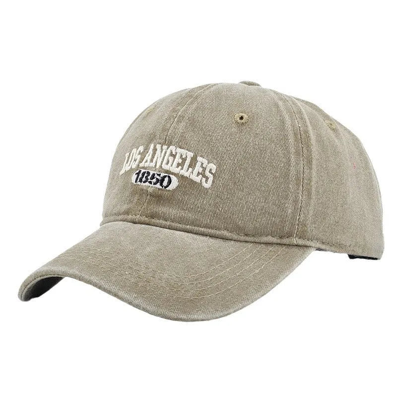 Retro-style personalised baseball cap with distressed letter embroidery on an adjustable strap, shown in beige colour.