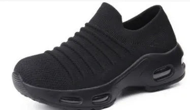 Women's fly-knit stretch sock shoes in light grey with low heel and round toe.
