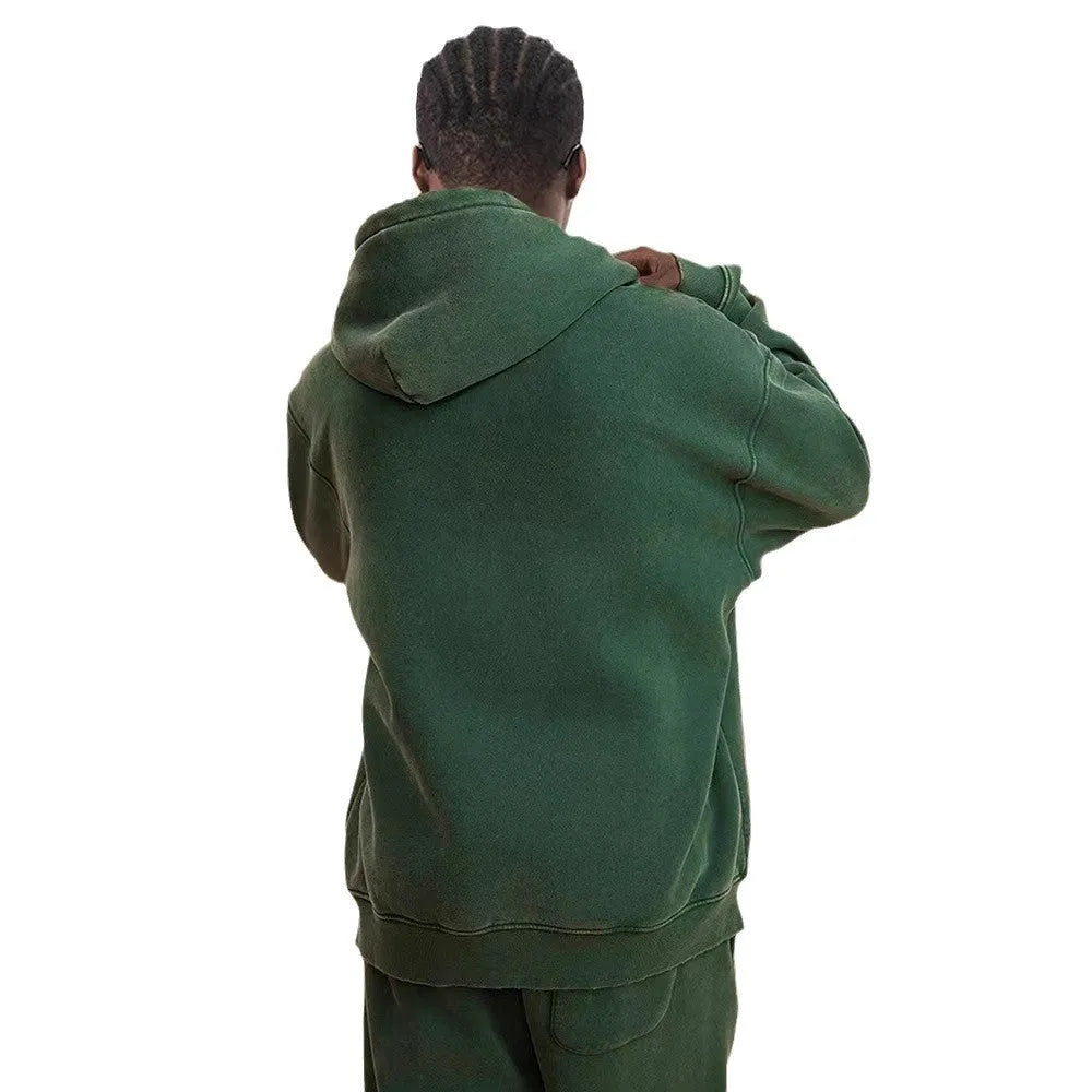 Man wearing a washed black hooded cardigan with a double zipper and fleece lining