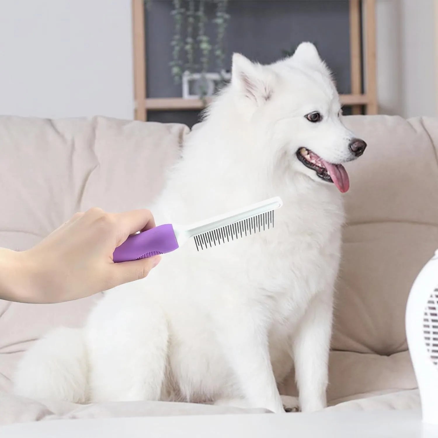 Purple handled pet comb with stainless steel teeth for detangling dog and cat fur.