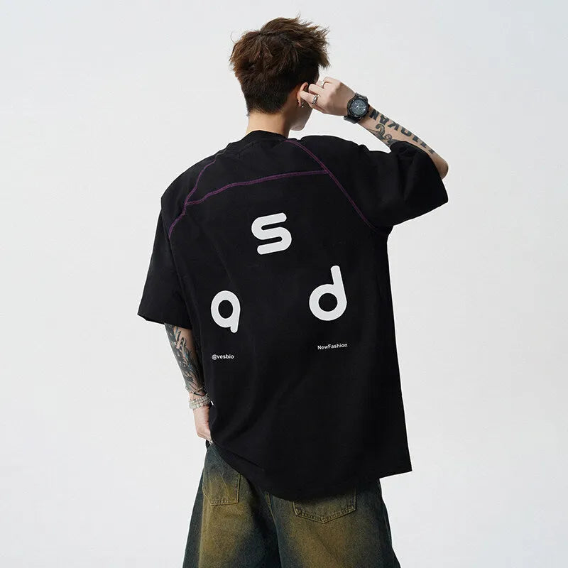 A loose-fitting black cotton t-shirt with letter print detail on the front, showing short sleeves and a round neck.