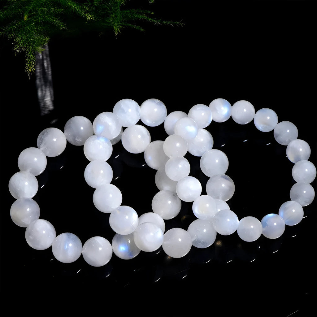 Natural blue moonlight round bead moonstone bracelet on wrist showing polished gemstone beads