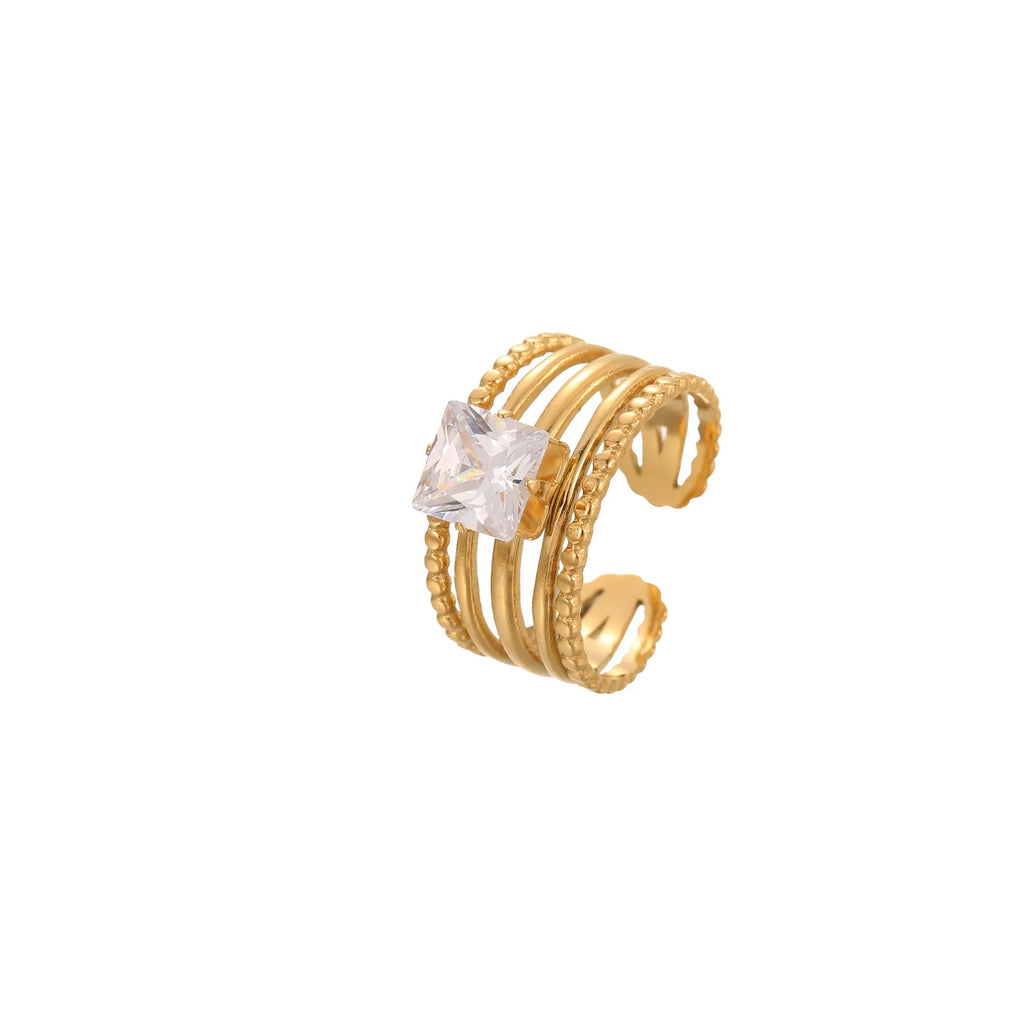 Gold-coloured adjustable stainless steel ring with zircon geometric shapes on white background.