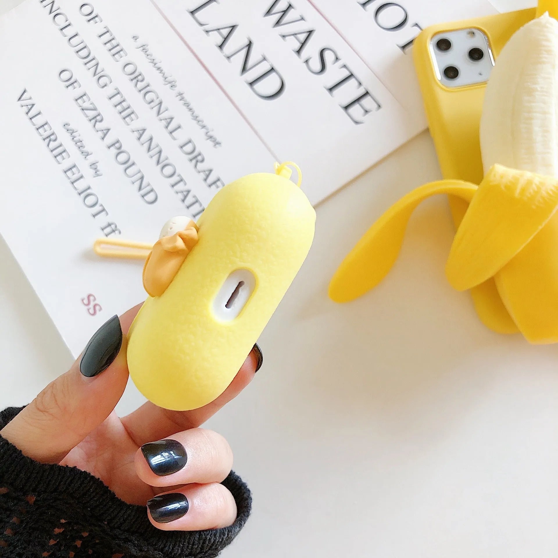 Yellow banana-coloured IMD back cover case for iPhone models 6 through 13 Pro Max on a table.