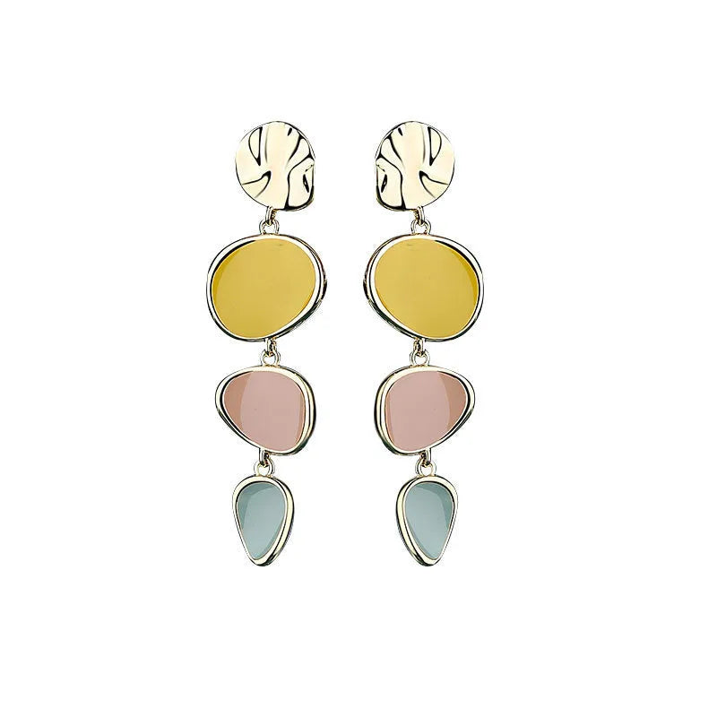 A pair of thin sterling silver stud earrings with Morandi-coloured wafer discs featuring an oil-drip texture.